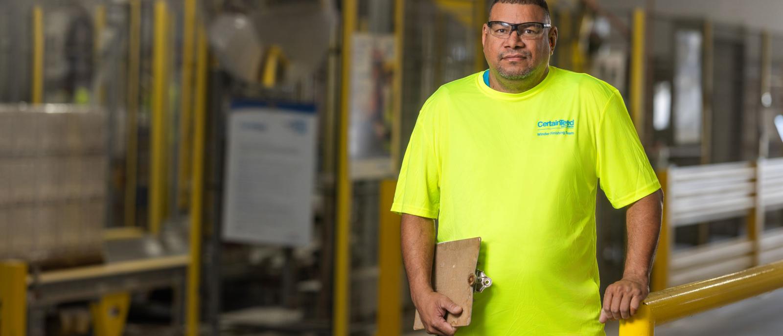 An engineer wearing bright safety gear, representing growth and opportunity for anyone pursuing a manufacturing engineer career path.